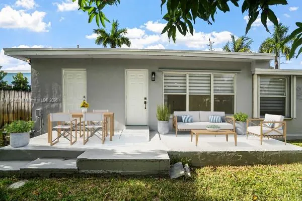 a view of the patio with couches table and chairs and potted plants