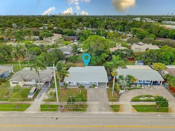 an aerial view of a house with a yard