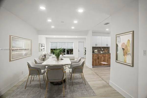 a dining room with furniture and window