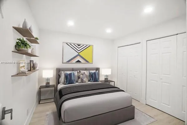 a bedroom with a bed and painting on the wall