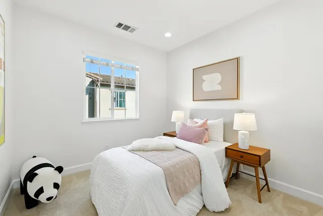 a bedroom with a bed and a lamp