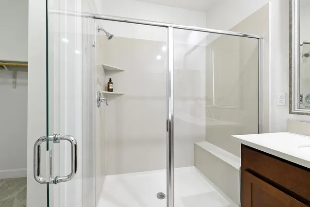a bathroom with a shower and a bath tub