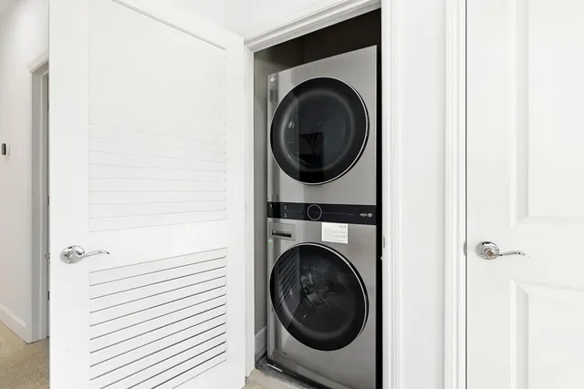 a close view of a utility room with dryer and washer