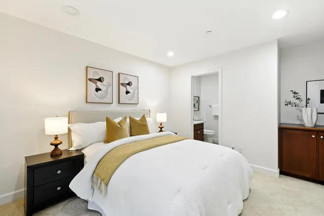 a bed room with a bed and a night stand