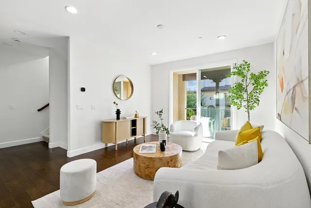 a living room with furniture and a potted plant