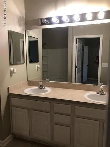 a bathroom with a sink and a mirror