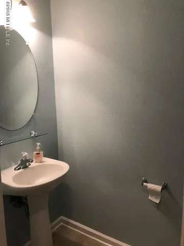 a bathroom with a sink and mirror