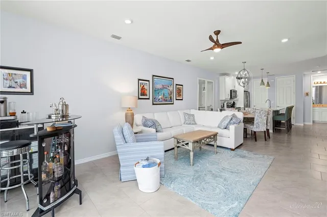 a view of a dining room with furniture and a chandelier