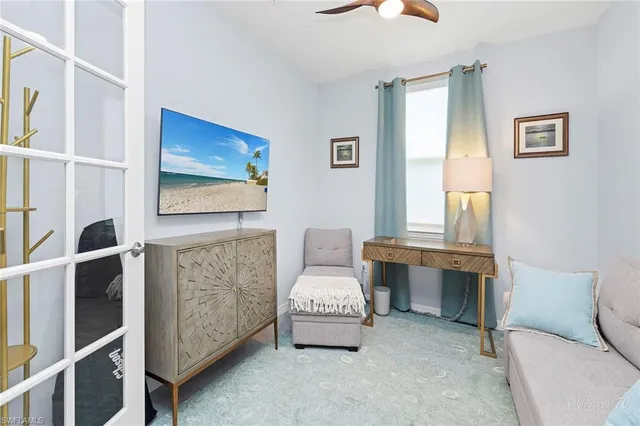 a living room with furniture and a potted plant