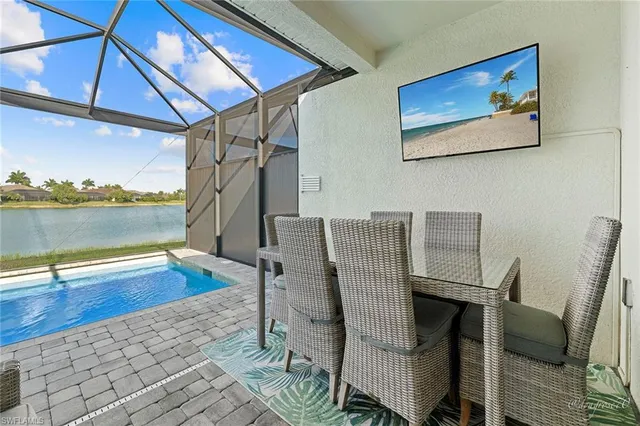 a view of swimming pool with outdoor seating