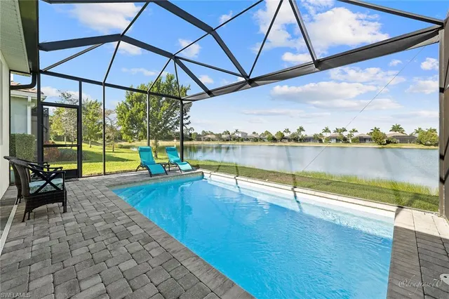 a view of a swimming pool and an outdoor seating