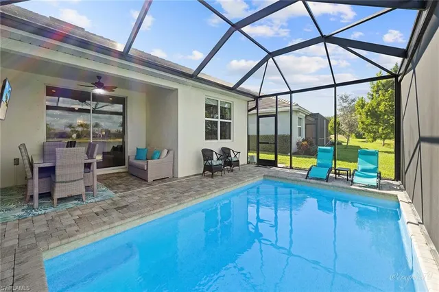 a view of a swimming pool with an outdoor seating space