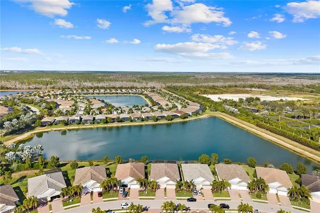 an aerial view of residential houses with outdoor space and river