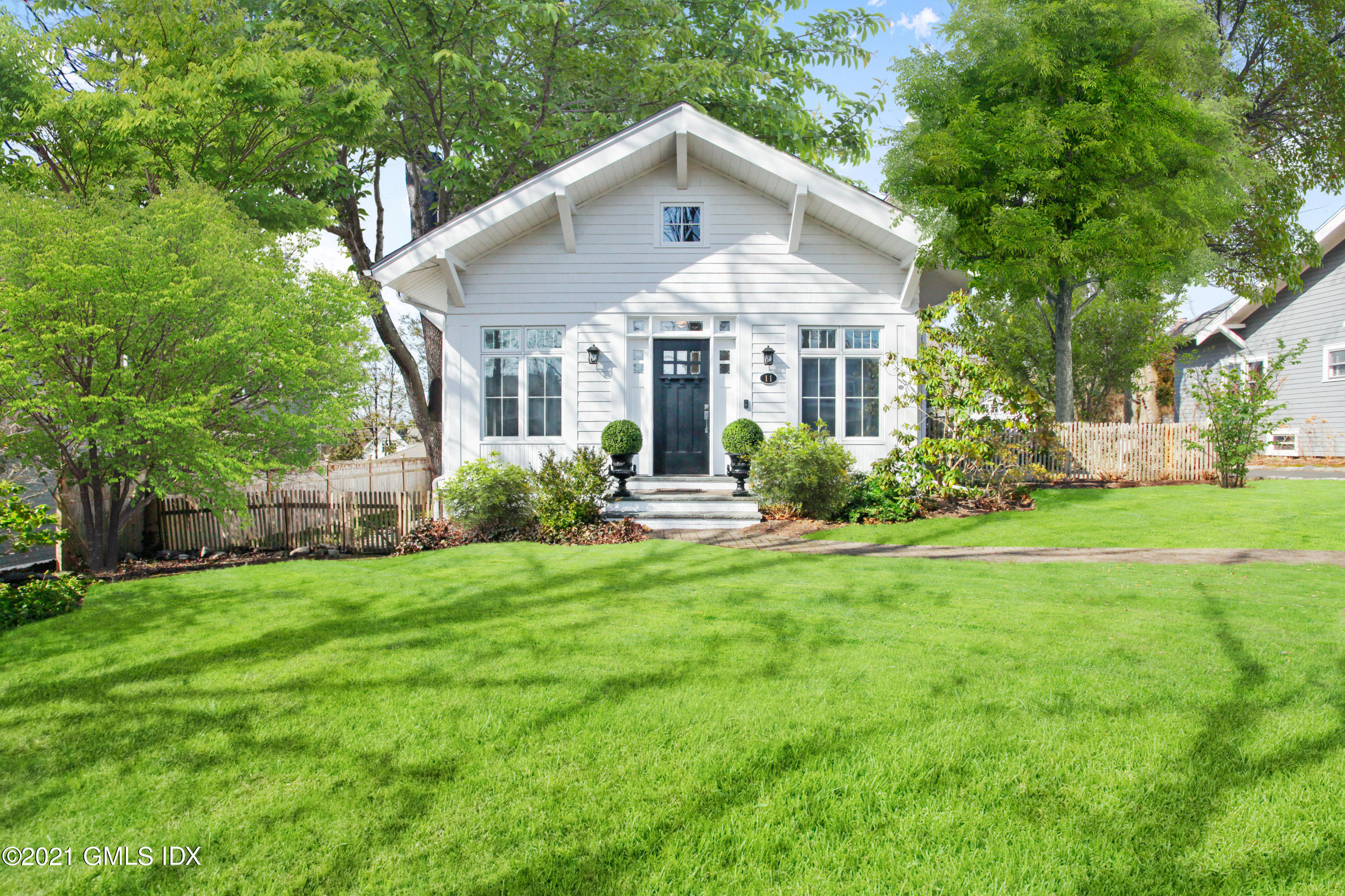a front view of a house with garden