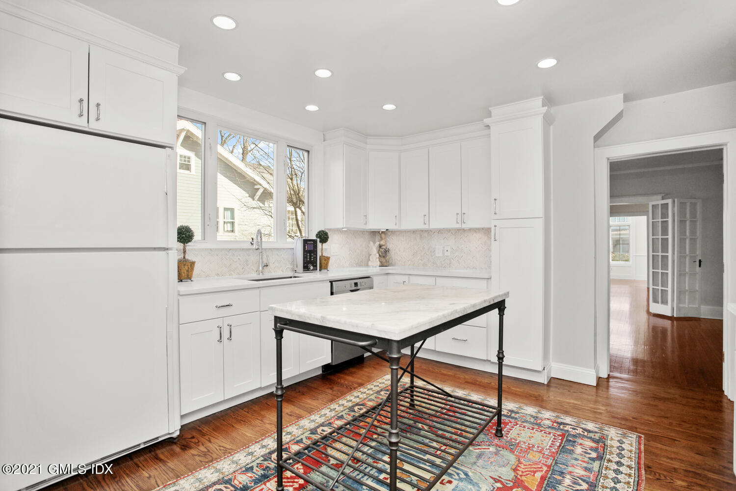 11 Chapel Lane Riverside, CT 06878 - Photo 14 of 33 a kitchen with a sink a refrigerator and wooden floor