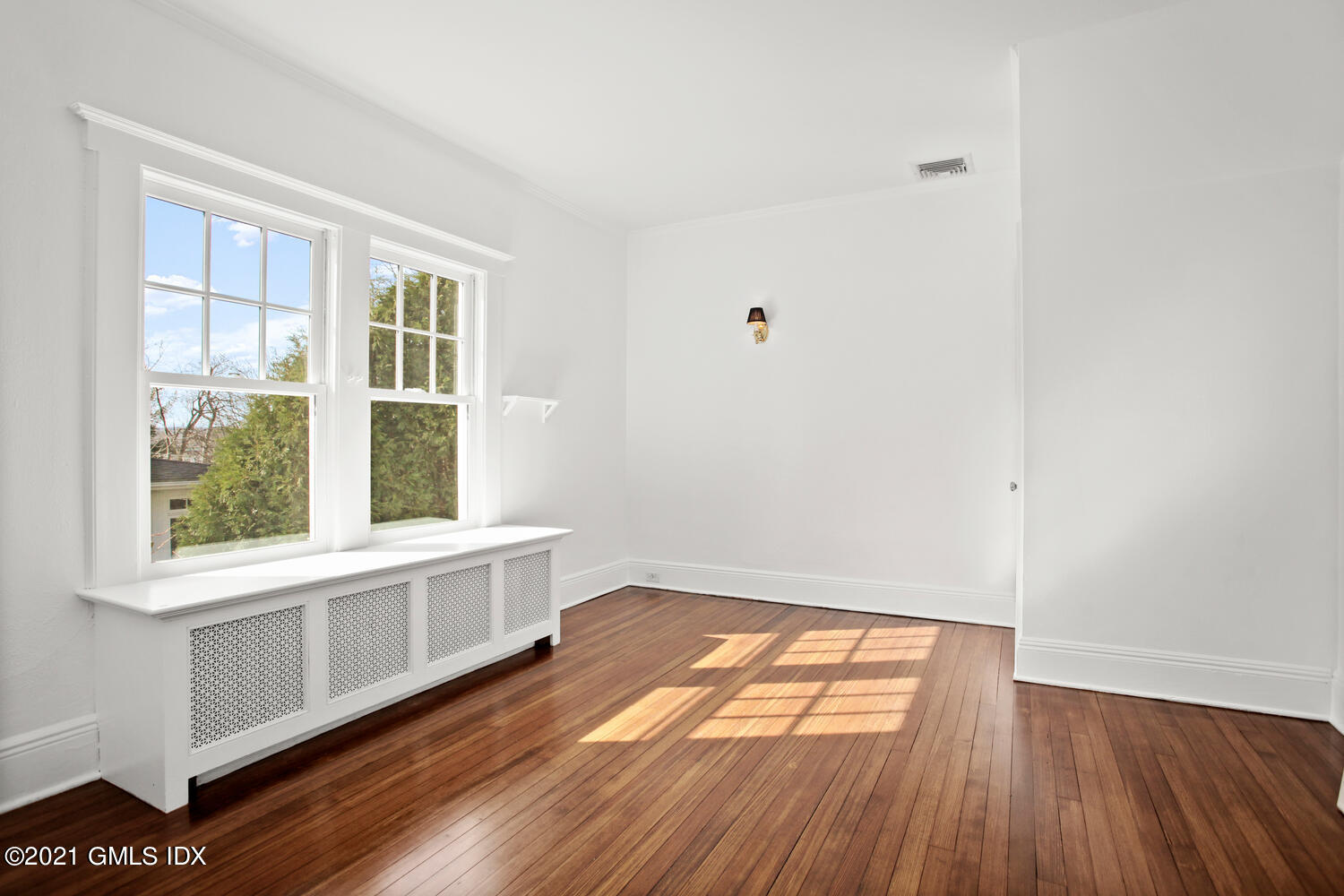 11 Chapel Lane Riverside, CT 06878 - Photo 18 of 33 a view of an empty room with wooden floor and a window