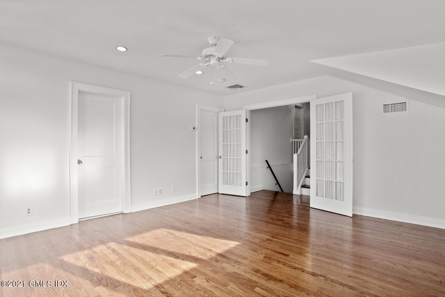 11 Chapel Lane Riverside, CT 06878 - Photo 20 of 33 a view of an empty room with wooden floor and staircase