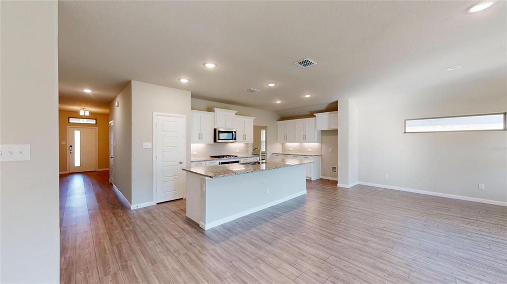 603 Cherry Hill Road Red Oak, TX 75154 - Photo 11 of 32 a view of kitchen with kitchen island stainless steel appliances refrigerator stove microwave and cabinets