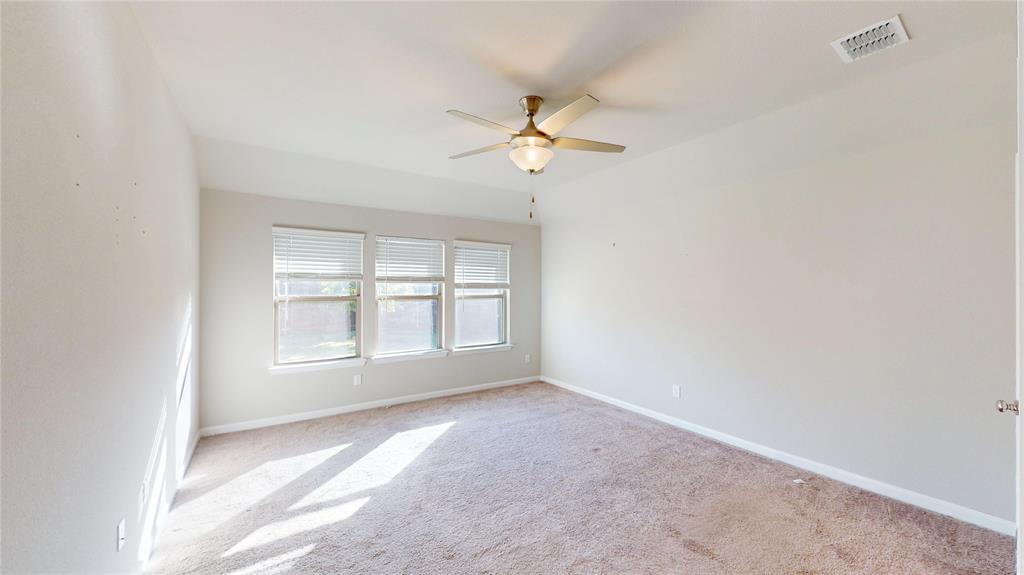 603 Cherry Hill Road Red Oak, TX 75154 - Photo 12 of 32 an empty room with a window and a fan