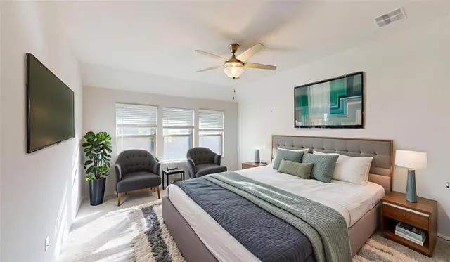 a bedroom with furniture and a flat screen tv