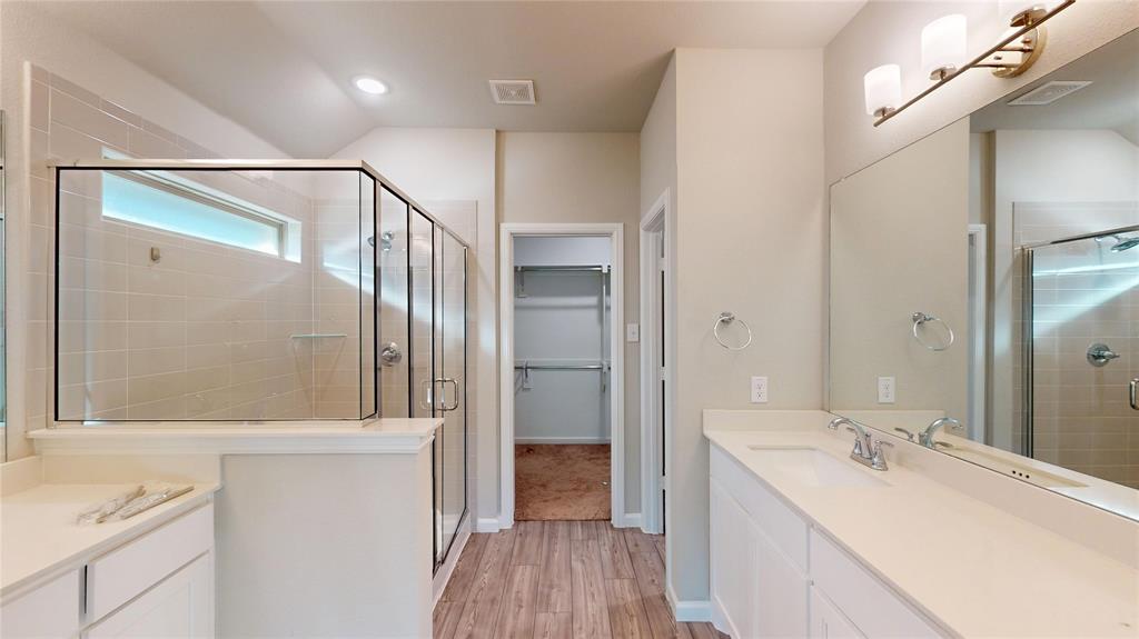 603 Cherry Hill Road Red Oak, TX 75154 - Photo 19 of 32 a bathroom with a sink a mirror and a shower