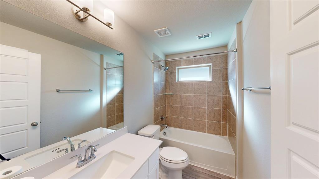 603 Cherry Hill Road Red Oak, TX 75154 - Photo 24 of 32 a bathroom with a sink a toilet and shower