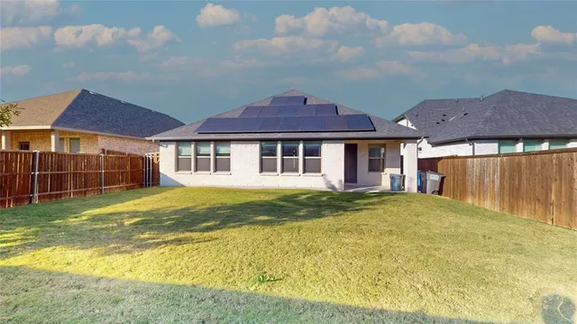 a close up of a vase of flowers sitting on a table