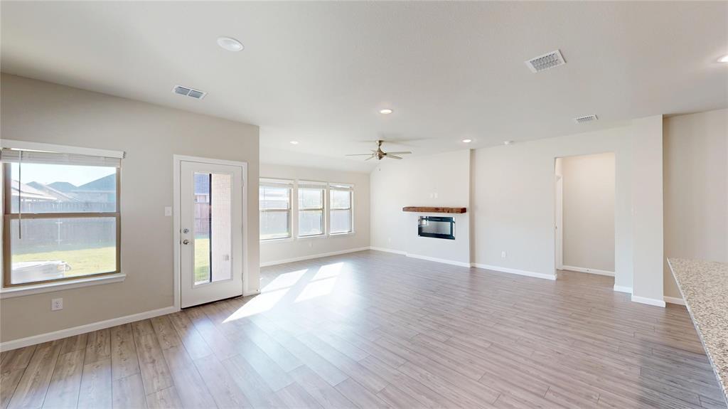 603 Cherry Hill Road Red Oak, TX 75154 - Photo 5 of 32 a view of an empty room with wooden floor and a window