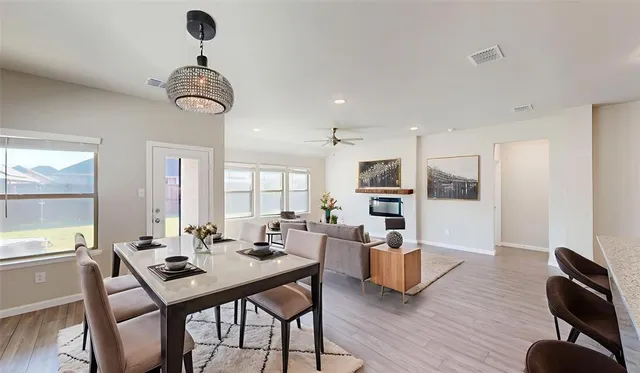 a view of a dining room with furniture window and wooden floor