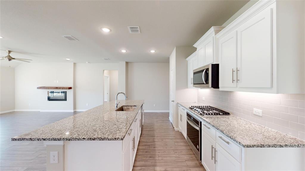 603 Cherry Hill Road Red Oak, TX 75154 - Photo 10 of 32 a kitchen with stainless steel appliances granite countertop a sink stove and cabinets