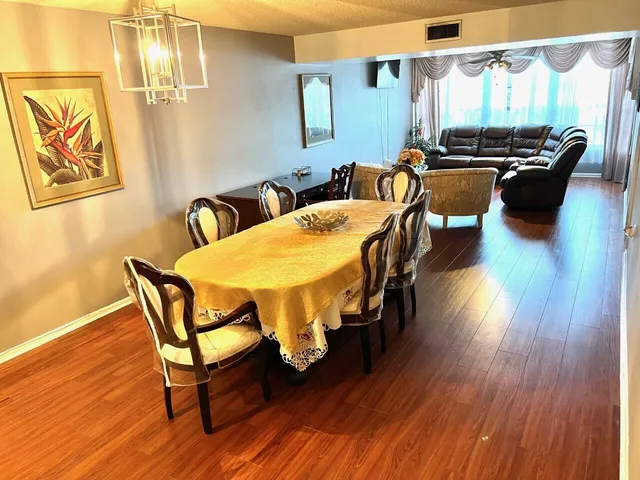 a dining room with furniture and wooden floor