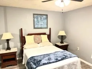 a bedroom with a bed and a lamp on table