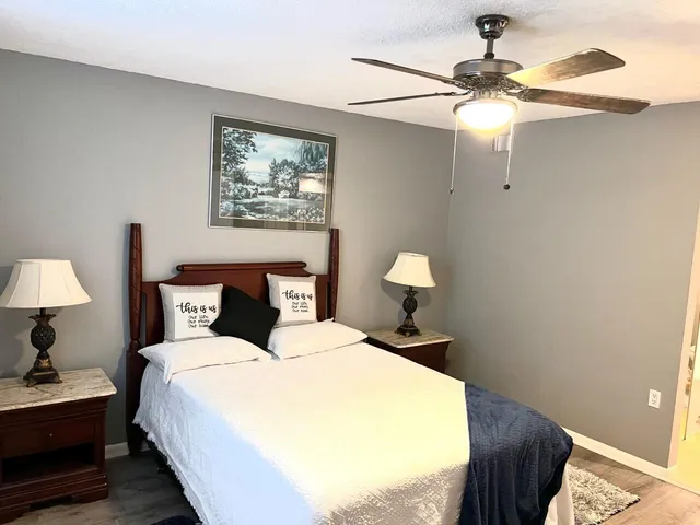 a bedroom with a bed and a chandelier