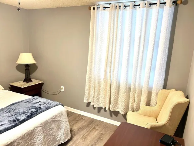 a bedroom with a bed and a chair