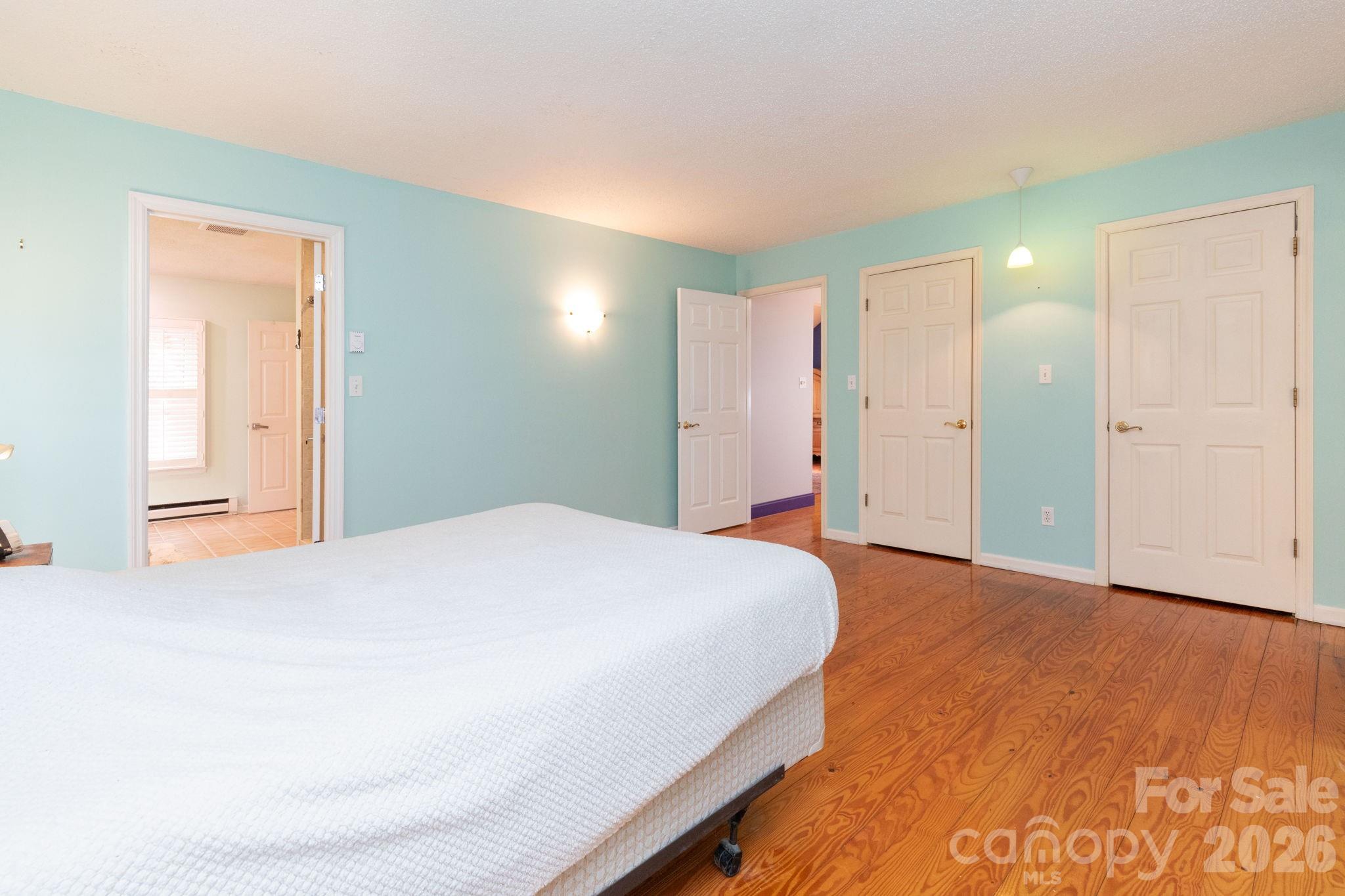 341 Sugar Hollow Road Fairview, NC 28730 - Photo 11 of 24 a bedroom with a bed and a cabinets