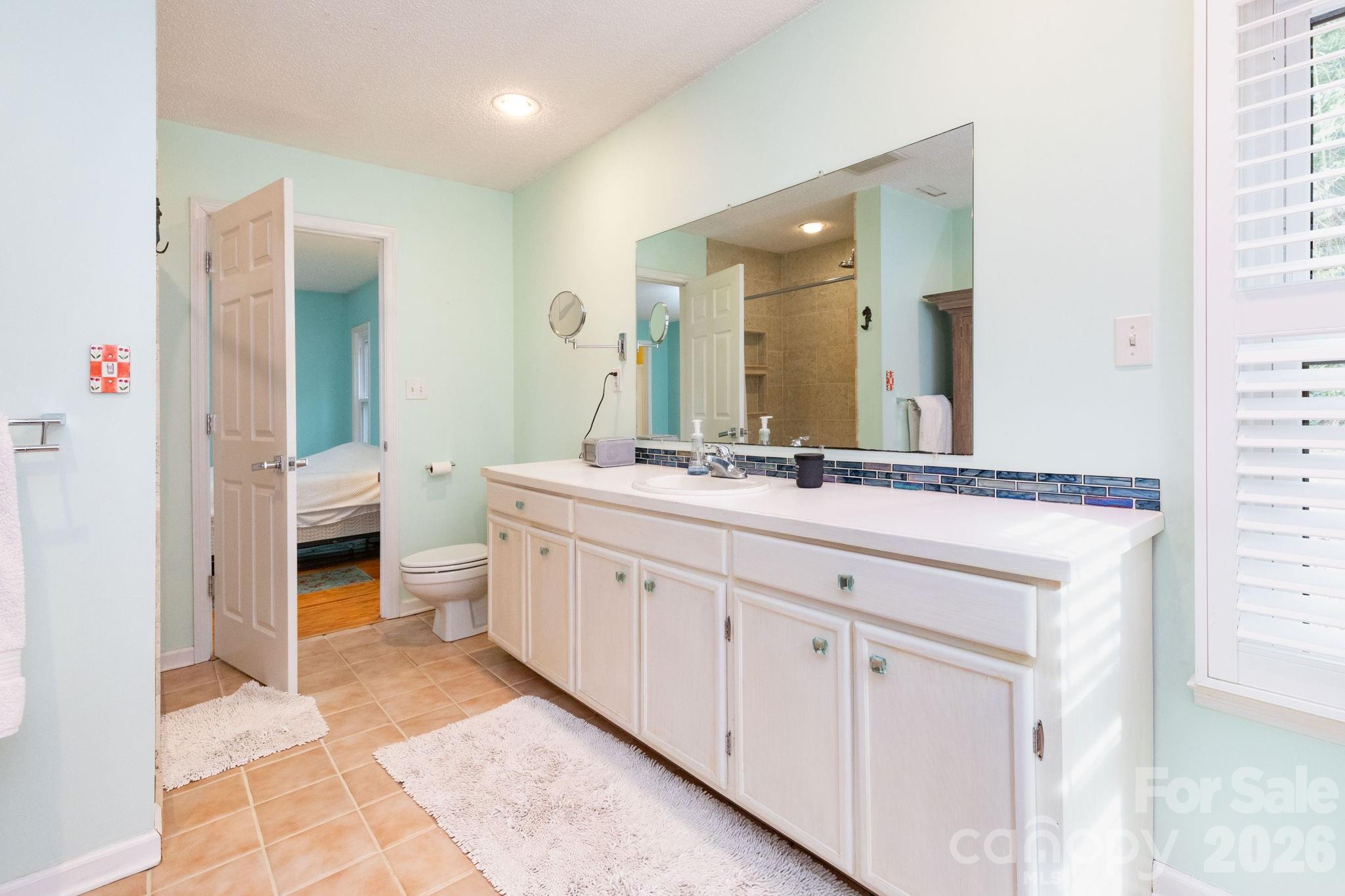 341 Sugar Hollow Road Fairview, NC 28730 - Photo 12 of 24 a bathroom with a double vanity sink and a mirror