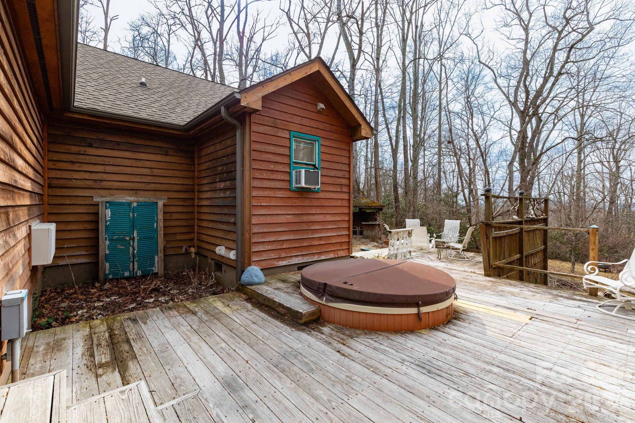 341 Sugar Hollow Road Fairview, NC 28730 - Photo 17 of 24 a wooden bench sitting next to a house