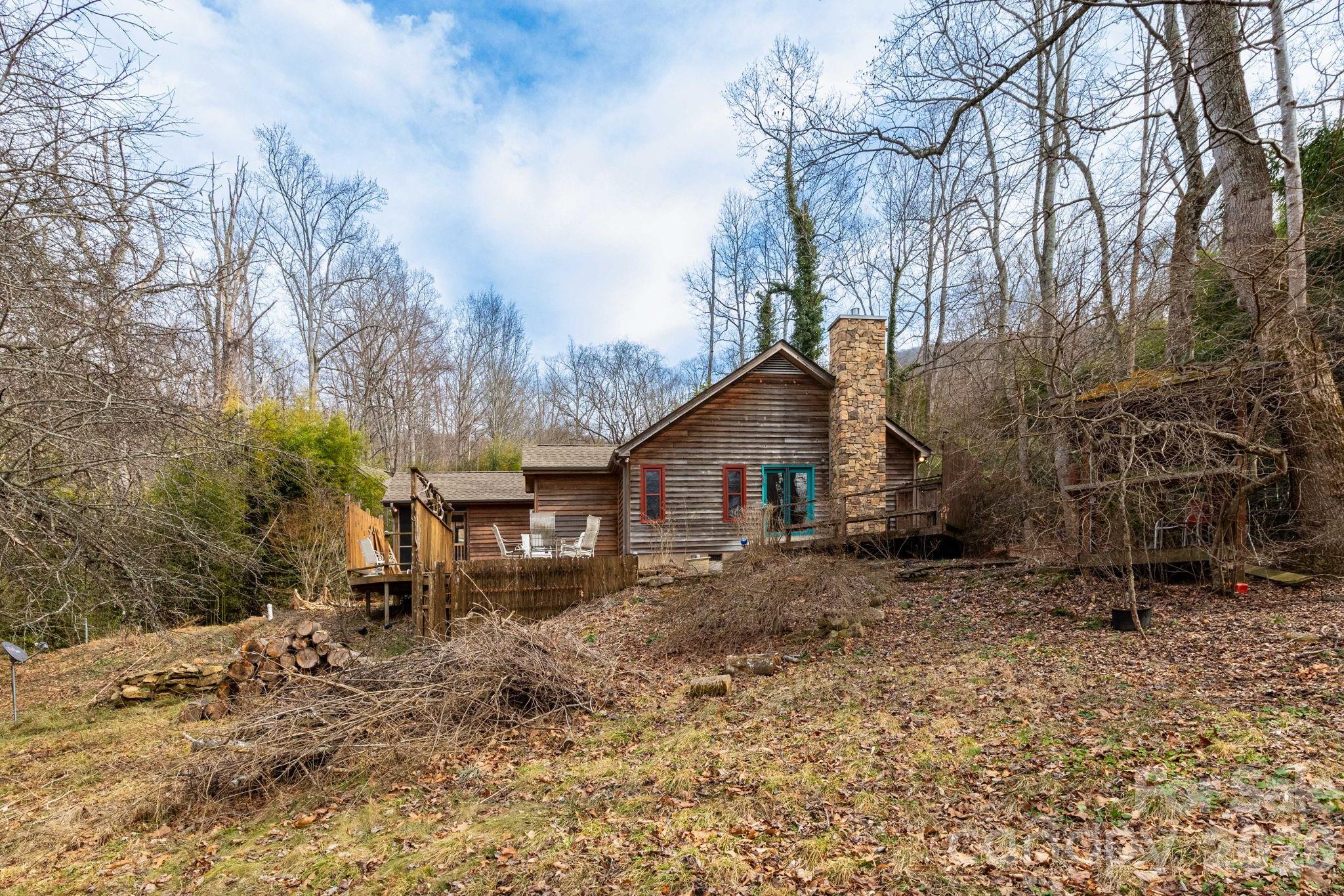 341 Sugar Hollow Road Fairview, NC 28730 - Photo 20 of 24 a view of a house with a yard covered in snow