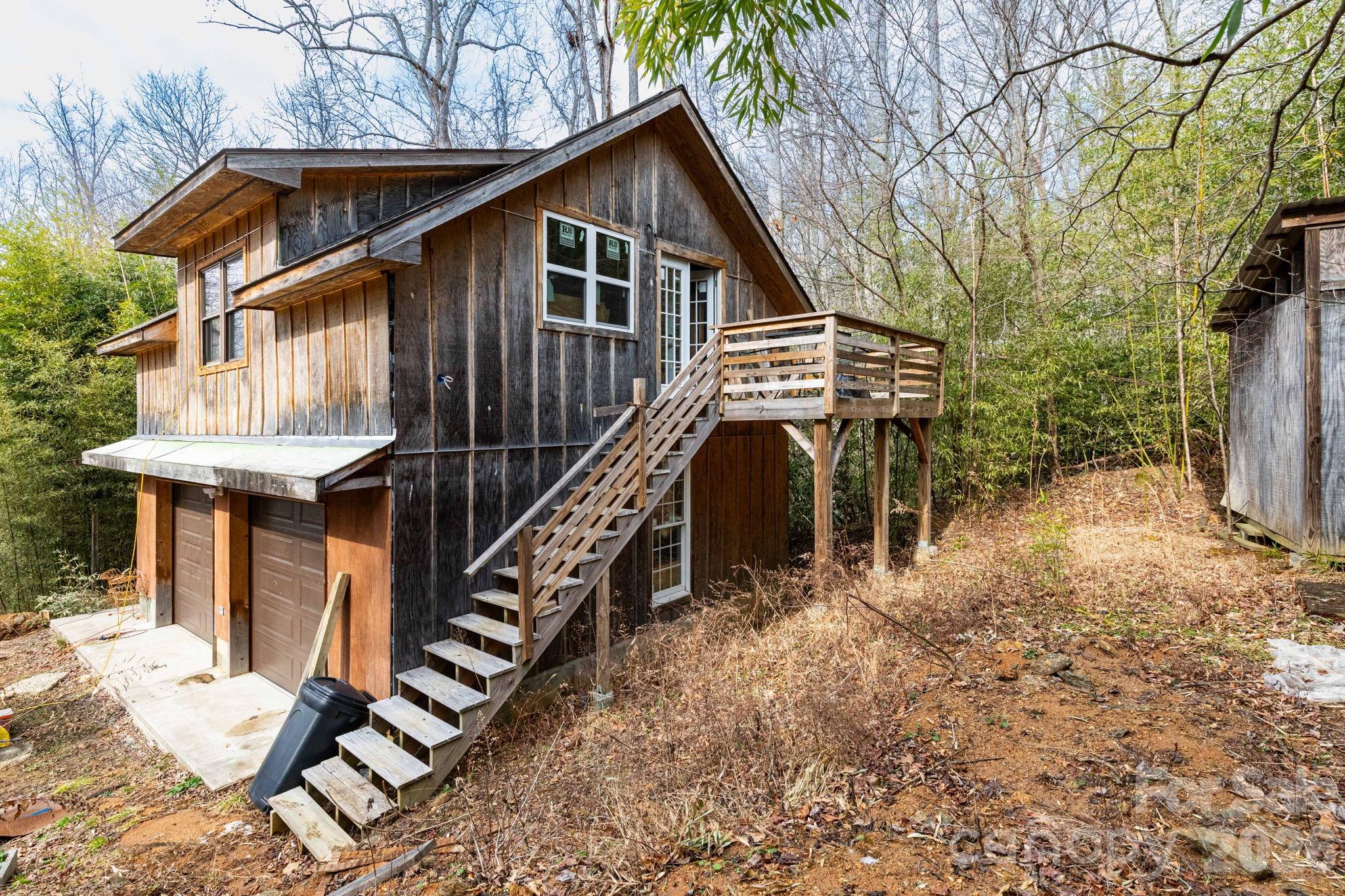 341 Sugar Hollow Road Fairview, NC 28730 - Photo 21 of 24 a front view of house with wooden stairs and seating space