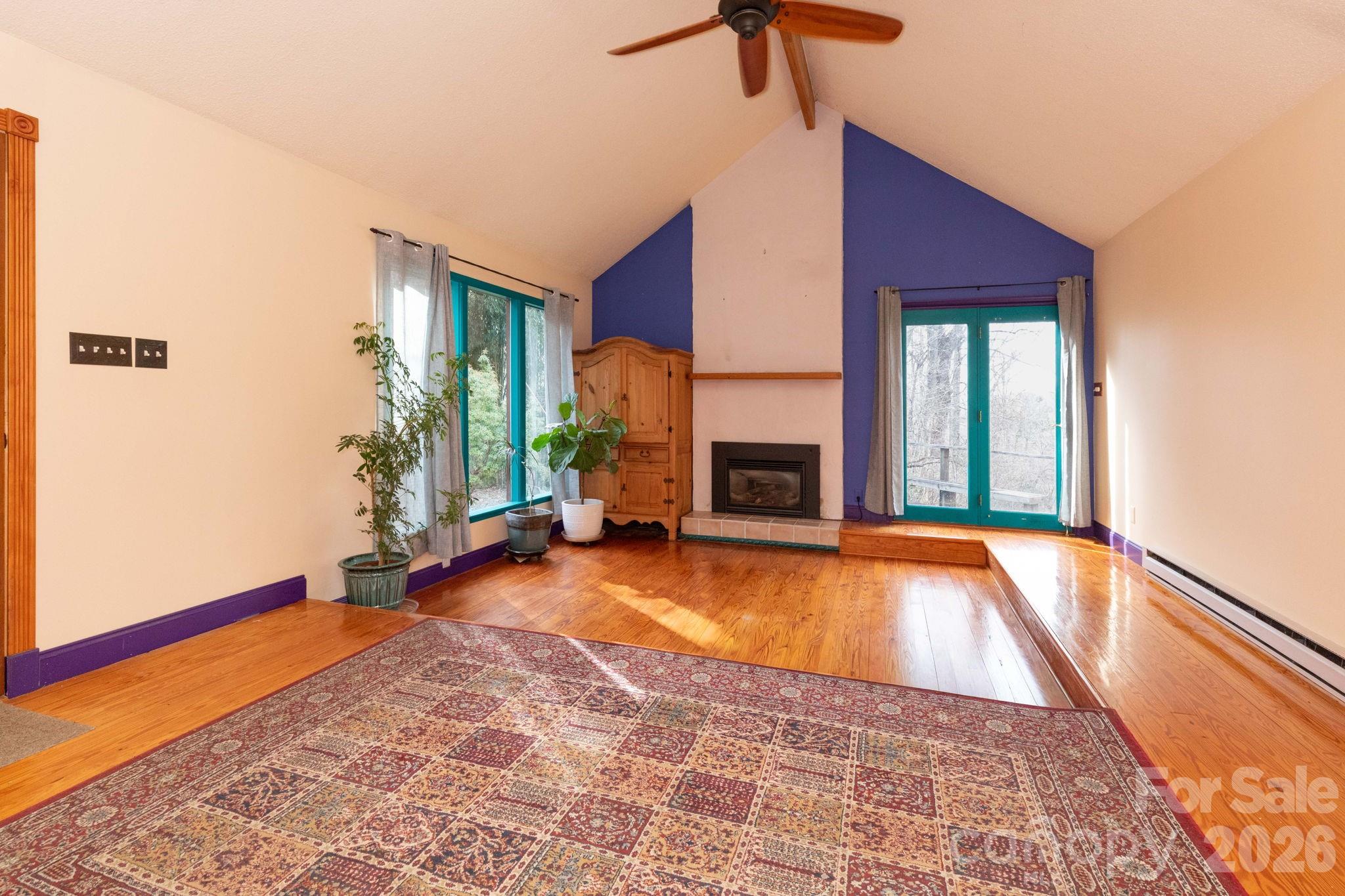 341 Sugar Hollow Road Fairview, NC 28730 - Photo 6 of 24 a view of an empty room with window and fire place