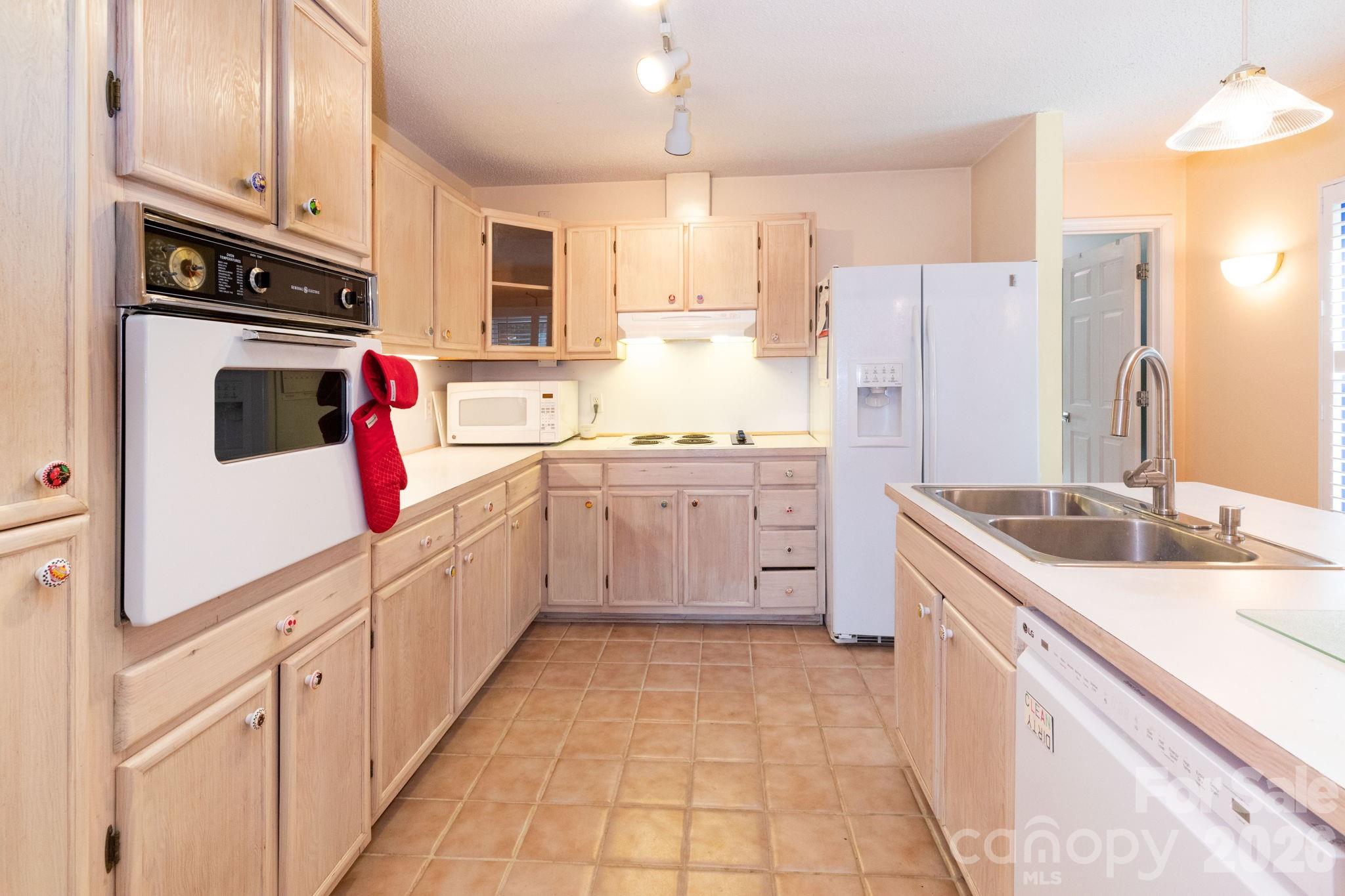 341 Sugar Hollow Road Fairview, NC 28730 - Photo 8 of 24 a kitchen with a sink stove and refrigerator