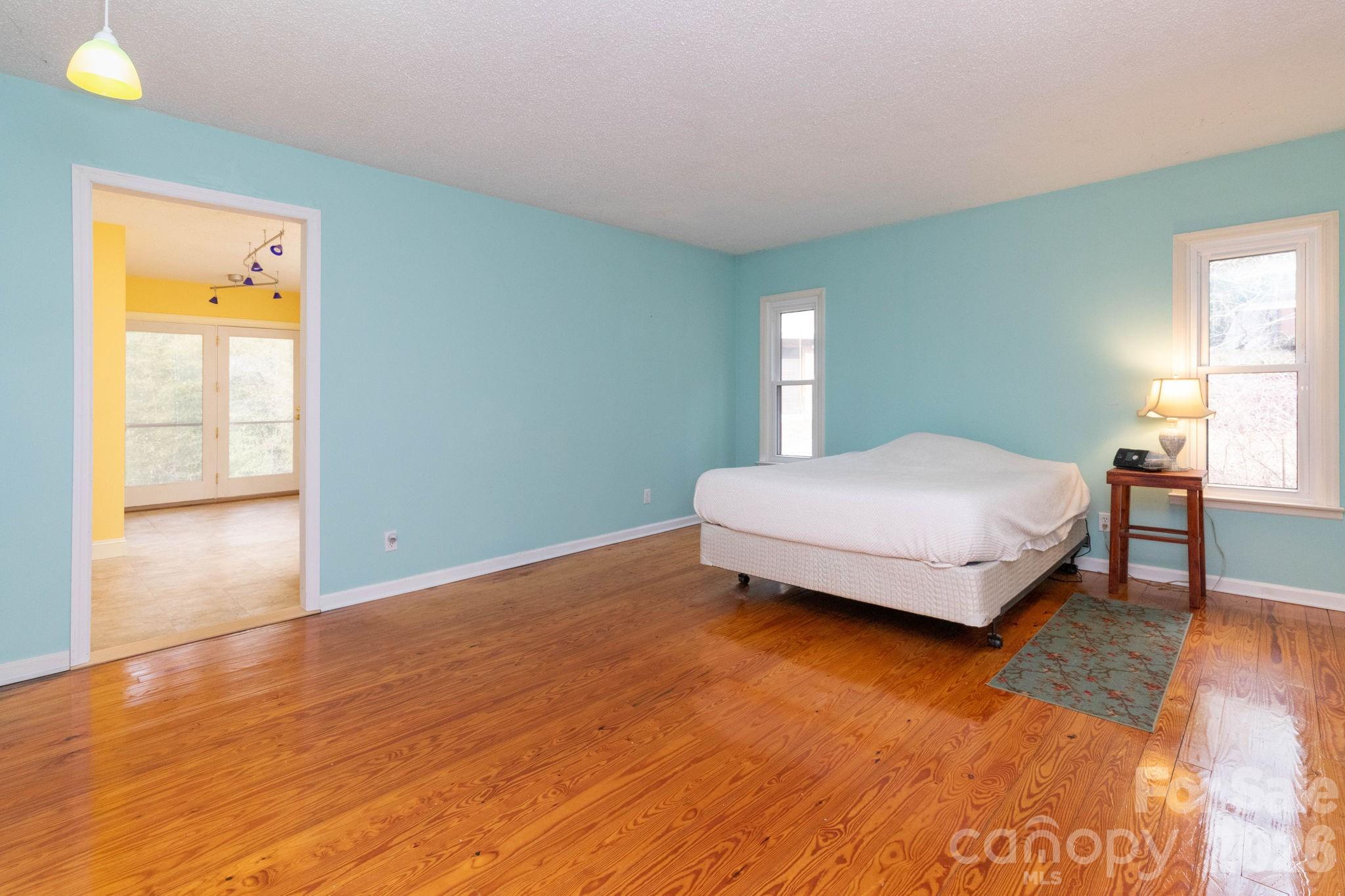 341 Sugar Hollow Road Fairview, NC 28730 - Photo 10 of 24 a bedroom with a bed and window