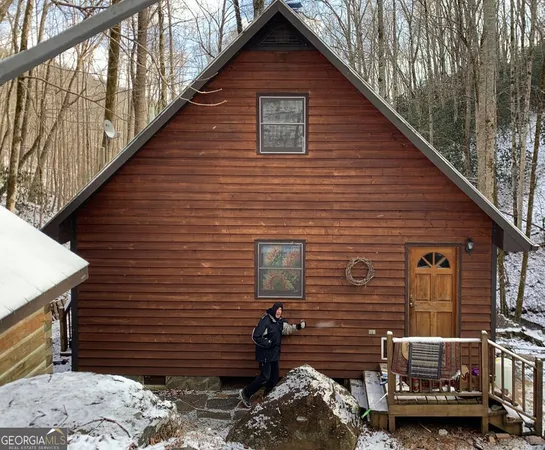 a view of a backyard with brick wall and seating space