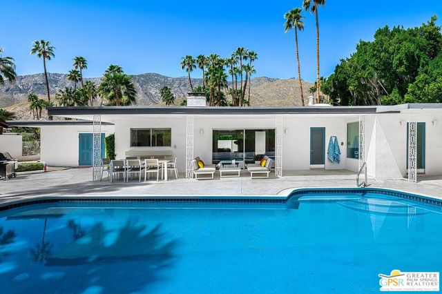 a view of a swimming pool with outdoor seating