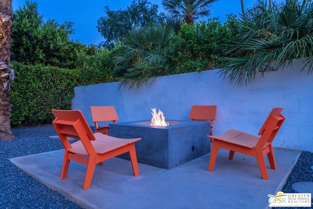 a view of a house with pool and chairs
