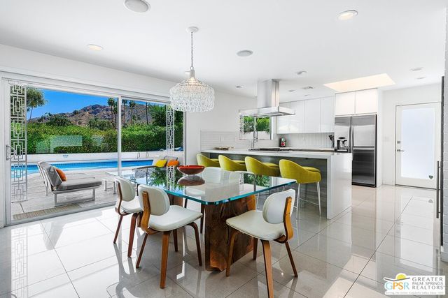 a view of a dining room with furniture window and outside view