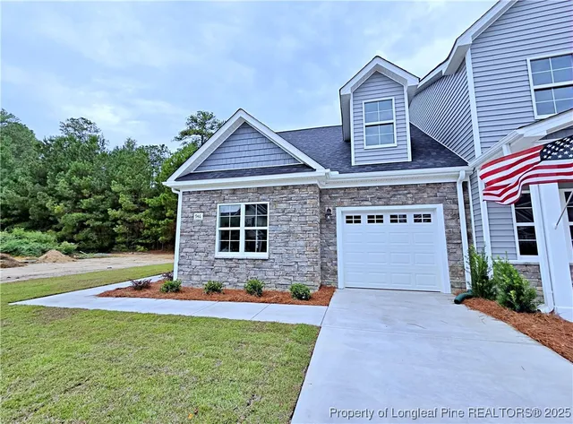 a front view of house with yard outdoor seating and barbeque oven