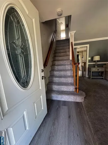 a view of entryway and hall with wooden floor