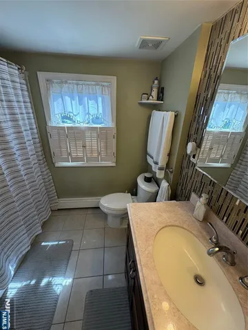 a bathroom with a sink a toilet and tub