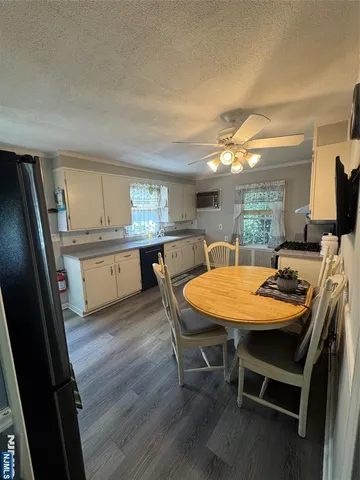 a dining room with a table chairs and a kitchen view